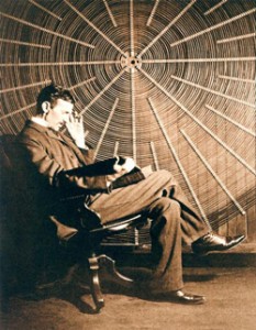Nikola Tesla in front of the spiral coil of his high-voltage transformer at East Houston St., New York.