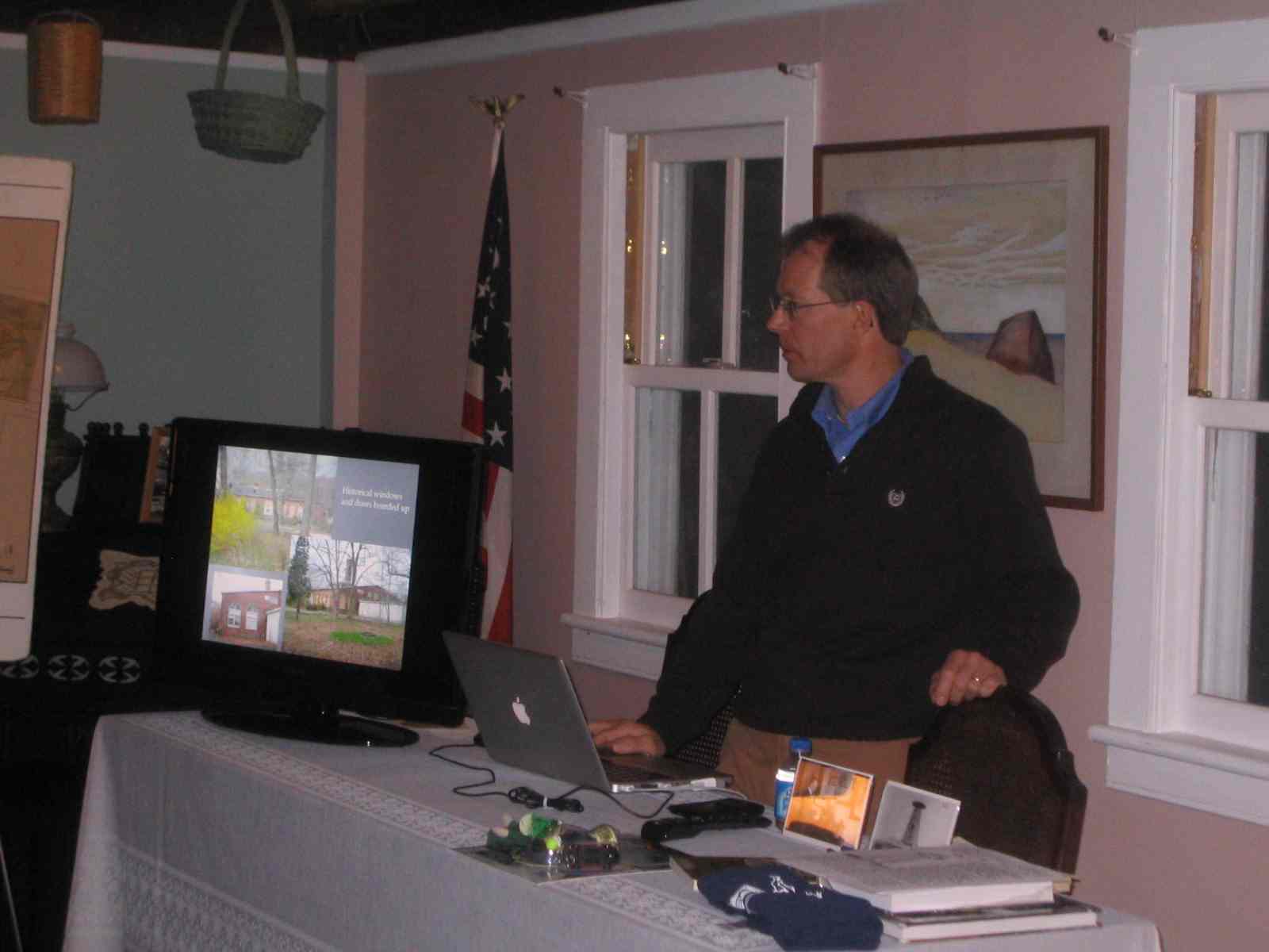 TSC Secretary Chris Wesselborg giving a virtual tour of the
        Tesla site and laboratory. (Photo by Bob Alcorn)